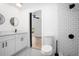 Modern bathroom with white subway tile shower, black hardware, and black and white mosaic tile floor at 415 W Church St, Deland, FL 32720