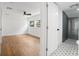 Bright bedroom leading to a bathroom with gray tiles and patterned floors at 415 W Church St, Deland, FL 32720