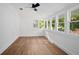 Bright bedroom with many windows, wood look floors, and ceiling fan at 415 W Church St, Deland, FL 32720