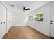 Bright bedroom with hardwood floors, ceiling fan, double closets, and large windows at 415 W Church St, Deland, FL 32720