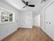 Sunny bedroom with hardwood floors, ceiling fan, and a view of the yard at 415 W Church St, Deland, FL 32720