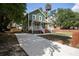 Charming two-story home features a covered front porch, green exterior, and a long driveway at 415 W Church St, Deland, FL 32720