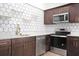 Modern kitchen features stainless steel appliances, quartz countertops, and a stylish backsplash at 415 W Church St, Deland, FL 32720