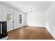 Bright living room featuring hardwood floors, a modern light fixture, and a large window at 415 W Church St, Deland, FL 32720