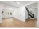 Open living room with hardwood floors, natural light, and access to a staircase at 415 W Church St, Deland, FL 32720