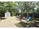 Lush backyard with a playset, storage shed, and ample green space for recreation at 421 Hope Ter, Maitland, FL 32751