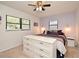 Cozy bedroom featuring ceiling fan, natural light, neutral paint, and an ensuite bathroom at 421 Hope Ter, Maitland, FL 32751