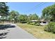 Landscaped front yard view of a charming home, enhanced by lush trees and a serene neighborhood setting at 421 Hope Ter, Maitland, FL 32751