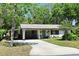 Charming single-story home featuring a covered carport, manicured lawn, and inviting curb appeal at 421 Hope Ter, Maitland, FL 32751