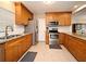 Traditional eat-in kitchen featuring granite counters, wood cabinets, stainless appliances, and tile flooring at 421 Hope Ter, Maitland, FL 32751