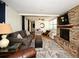 Cozy living room with a brick fireplace, plush sofa, and open layout perfect for Gathering gatherings at 421 Hope Ter, Maitland, FL 32751