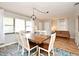 Well-lit living and dining space featuring wood floors and neutral paint at 421 Hope Ter, Maitland, FL 32751