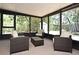 Bright sunroom with comfortable seating and views of the lush backyard at 421 Hope Ter, Maitland, FL 32751