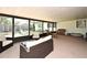 Relaxing sunroom with wicker furniture, screened windows, and access to the backyard at 421 Hope Ter, Maitland, FL 32751