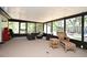 Spacious sunroom featuring wicker furniture, screened windows, and natural light at 421 Hope Ter, Maitland, FL 32751