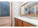 Small bathroom with floral wallpaper, mirror and vanity, and a door with blue glass at 4293 Cypress Bnd, Geneva, FL 32732