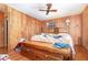 Wood paneled bedroom with ceiling fan, two windows, and a bed, appearing cluttered at 4293 Cypress Bnd, Geneva, FL 32732