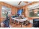 Wood paneled bedroom with windows, featuring a table covered in a variety of personal items at 4293 Cypress Bnd, Geneva, FL 32732