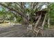 Waterfront home with a wooden dock and stairs to a gazebo with a thatched roof at 4293 Cypress Bnd, Geneva, FL 32732