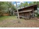 Exterior view of a waterfront home with a covered shed on the ground level at 4293 Cypress Bnd, Geneva, FL 32732