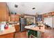Functional kitchen with wood cabinets and stainless-steel appliances, alongside rustic decor and ample counter space at 4293 Cypress Bnd, Geneva, FL 32732