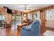 Bright living room features wood walls, comfortable seating and views of a screened porch at 4293 Cypress Bnd, Geneva, FL 32732