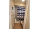Compact bathroom with a striped shower curtain and tiled floors at 4401 Sea Mist Dr # 201, New Smyrna Beach, FL 32169