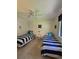Bright bedroom featuring two twin beds, tile floors, and a ceiling fan for added comfort at 4401 Sea Mist Dr # 201, New Smyrna Beach, FL 32169