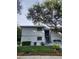 Inviting two-story exterior featuring well-maintained landscaping and stair access at 4401 Sea Mist Dr # 201, New Smyrna Beach, FL 32169