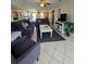 Open-concept living room boasts tile floors, ceiling fan, and comfortable seating area at 4401 Sea Mist Dr # 201, New Smyrna Beach, FL 32169