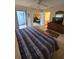 Tranquil main bedroom with a ceiling fan, tiled floors, and an ensuite bathroom at 4401 Sea Mist Dr # 201, New Smyrna Beach, FL 32169
