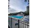 Large community pool with plenty of lounge chairs and a surrounding fence at 4401 Sea Mist Dr # 201, New Smyrna Beach, FL 32169