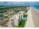 Coastal condominium building aerial view featuring an outdoor pool on the beach at 4505 S Atlantic Ave # 505, Ponce Inlet, FL 32127