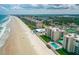 Breathtaking aerial view of beachside condos, sandy beach, and sparkling ocean at 4505 S Atlantic Ave # 505, Ponce Inlet, FL 32127