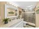 Modern bathroom featuring a walk-in shower, marble vanity and decorative mirror at 4505 S Atlantic Ave # 505, Ponce Inlet, FL 32127