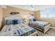 Guest bedroom featuring two beds with surf-themed decor and a ceiling fan at 4505 S Atlantic Ave # 505, Ponce Inlet, FL 32127