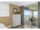 Bedroom view showcasing the dresser and a balcony with a beautiful ocean view at 4505 S Atlantic Ave # 505, Ponce Inlet, FL 32127