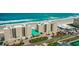 Beachfront condo complex with a pool, and palm trees, offering a luxurious coastal lifestyle with direct beach access at 4505 S Atlantic Ave # 505, Ponce Inlet, FL 32127