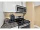 Well-equipped kitchen with stainless steel appliances and granite countertops at 4505 S Atlantic Ave # 505, Ponce Inlet, FL 32127