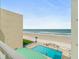 Oceanfront building view from above the pool overlooking the beach on a sunny day at 4505 S Atlantic Ave # 505, Ponce Inlet, FL 32127