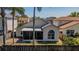 Residential back exterior featuring a screen porch, arched window, and fenced backyard offering a private outdoor space at 4534 Bond Ln, Oviedo, FL 32765
