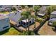 Backyard with screen porch, surrounded by a wooden fence and lush palm trees, offers privacy and outdoor enjoyment at 4534 Bond Ln, Oviedo, FL 32765