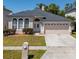 Charming one-story home featuring arched windows, a well-maintained lawn, and a two-car garage at 4534 Bond Ln, Oviedo, FL 32765