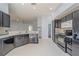 Contemporary kitchen features dark cabinets, granite countertops, and tile flooring at 4534 Bond Ln, Oviedo, FL 32765