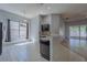 Eat-in kitchen with dark cabinets, countertop bar, light tile floors, and a view to the backyard at 4534 Bond Ln, Oviedo, FL 32765