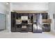 Modern kitchen with dark cabinets, stainless steel appliances, and ample counter space at 4534 Bond Ln, Oviedo, FL 32765
