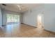 Open living room with tile flooring, ceiling fan, and sliding glass doors to the patio at 4534 Bond Ln, Oviedo, FL 32765