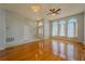 Bright living room with hardwood floors, arched windows, and modern ceiling fans at 4534 Bond Ln, Oviedo, FL 32765
