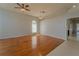 Open living room with hardwood floors, bright neutral walls, and modern ceiling fan and pendant lighting at 4534 Bond Ln, Oviedo, FL 32765