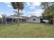 Expansive backyard featuring a screened-in pool area and detached garage at 481 W Holly Dr, Orange City, FL 32763